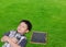 Sleeping Asian boy with magnifying glass