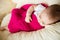 Sleeping baby covered with knitted blanket