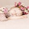 Sleeping baby girl in flowers, beautiful vintage background