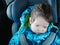 Sleeping baby rides in a car seat. Happy baby ride in a car. child safety. Cute boy sleeping in a car in the child seat