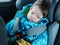 Sleeping baby rides in a car seat. Happy baby ride in a car. child safety. Cute boy sleeping in a car in the child seat