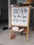 Sleeping cats and signboard