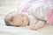 Sleeping child portrait in pastel tones.