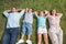 Sleeping family lying on the grass in a row