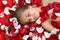 Sleeping girl in rose petal