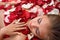 Sleeping girl in rose petal