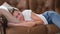 Sleeping lazy woman lies on couch during day