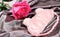 sleeping mask on a silk bedding sheet and pink rose, romantic evening concept, dating and love, relationship.