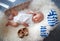 Sleeping newborn baby in basket on sheepskin