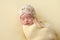 Sleeping Newborn Baby Girl Swaddled in Yellow