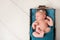 Sleeping Newborn Baby Girl in Wooden Crate