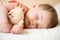 Sleeping newborn baby with teddy bear