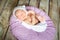 Sleeping newborn baby on a violet pillow