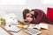 Sleeping overworking businessman with laptop in modern white office