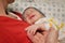 Sleeping smiling happy newborn babe holding hands with father close up