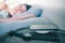 sleeping woman in bed cellphone charging on wireless charger