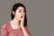 Sleepless Asian woman yawning and tired from insomnia with dark eyes circle