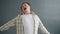 Sleepy Asian man yawning feeling tired or bored standing on gray background