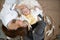 Sleepy baby in a wicker cradle in warmth near a happy caring mother. Happy motherhood concept