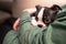 A sleepy Boston Terrier puppy being cuddled in the arms of its owner