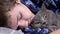 Sleepy Child Hugging a Fluffy Cat, Lying on a Bed in a Bedroom, Close up