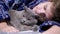 Sleepy Child Hugging a Fluffy Cat, Lying on a Bed in a Bedroom, Close up