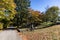 Sleepy Hollow Cemetery with Old Tombstones and Colorful Trees during Autumn along a Path