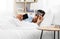 Sleepy indian man with smartphone lying in bed