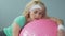 Sleepy tired middle-aged woman lying on fitness ball after active workout