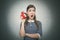 Sleepy woman with red alarm clock on gray background.