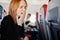 a sleepy woman yawns in an airplane seat. long flights.