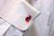 Sleeve of a white shirt with a red cuff link