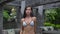 Slender adult girl in bathing suit going towards camera, model walks outside