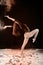 Slender blonde dancing in white dust studio shot