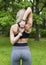 Slender blonde girl from the back, holding her hands in the castle behind her back , training in the Park among the greenery