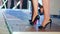 Slender female legs on High-heeled shoes walking along podium on fashion show