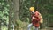 Slender girl goes along the path to the top in the coniferous forest. Tourism in the Caucasus Reserve. Will approach the