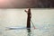 slender girl on stand up paddleboard on sunset background. SUP01