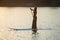 slender girl on stand up paddleboard on sunset background. SUP02