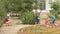 Slender girl takes pictures of children returning from school on background of flowers