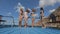 Slender girls in bikinis dancing on the pleasure boat that is in the sea