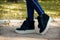 Slender legs in jeans shod in trend boots with fur and ears on a white thick sole