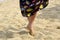 Slender legs of woman dance on sand