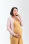 A slender pregnant woman holds a delicious healthy bread