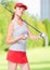 Slender sportswoman golfer with stick and ball