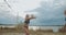 Slender sportswomen are playing volleyball on beach, slow motion shot of jumping players, pass and attack