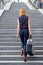 Slender stylish woman walking up a flight of stairs in town