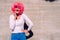 Slender and ugly woman with colorful wig posing ridiculously