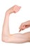 Slender woman showing her biceps. White background