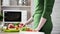 Slender woman taking fresh red apple from table, healthy nutrition, breakfast